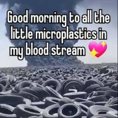 An industrial tire landfill scene overlaid with a cheerful greeting about microplastics contaminating the bloodstream, decorated with a pink sparkle heart.
