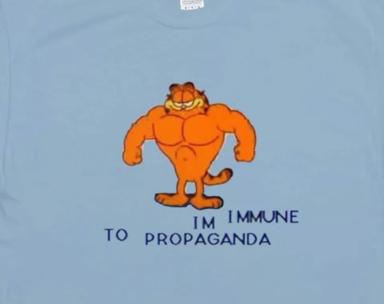 Buff Garfield declares immunity to propaganda—a joke about cynical indifference as accidental resistance.