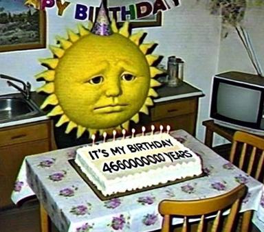 A long-faced sun-creature in a party hat celebrates 4.6 billion years with a birthday cake, deadpan and vaguely terrifying.