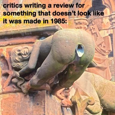 Stone gargoyle with bewildered expression on weathered building corner; text jokes about critics unable to review modern aesthetics.