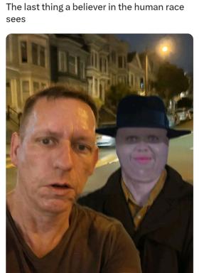 Two figures on a night street: one expressing shock/dismay, the other wearing a bowler hat with neutral expression. Text above: "The last thing a believer in the human race sees."