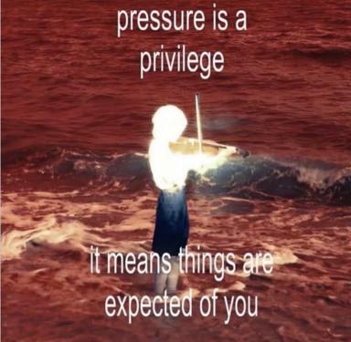 A surreal meme reframing "pressure is a privilege" as existential burden: a ghostly figure holding a violin on a barren reddish landscape, head replaced by a glowing white sphere.