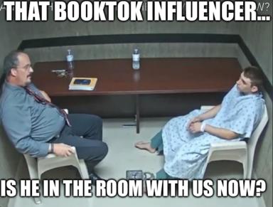 Two men in hospital gowns in a grey institutional room, separated by a table—a meme on BookTok influencer paranoia using the "is X in the room with us" anxiety format.